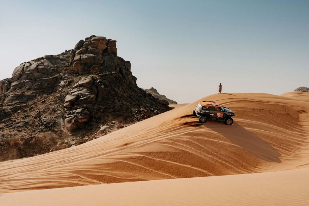 Vehículo del Dakar 2026 ascendiendo una duna en Arabia Saudí durante la etapa 12